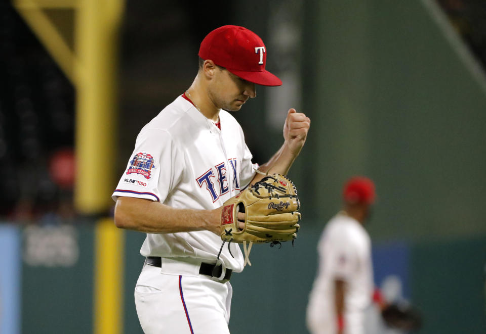 Texas Rangers starting pitcher Brock Burke pounds his glove with his fist after getting Los Angeles Angels' Albert Pujols to fly out to right for the final out in the top of the sixth inning of a baseball game in Arlington, Texas, Tuesday, Aug. 20, 2019. Burke made his major league debut in the game. (AP Photo/Tony Gutierrez)
