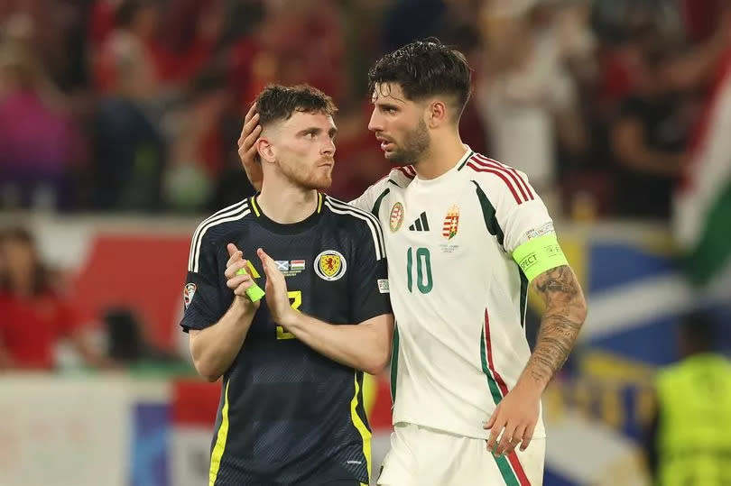 Andy Robertson of Scotland is seen with Dominik Szoboszlai of Hungar during the UEFA EURO 2024 group stage match between Scotland and Hungary at Stuttgart Arena on June 23, 2024 in Stuttgart, Germany.