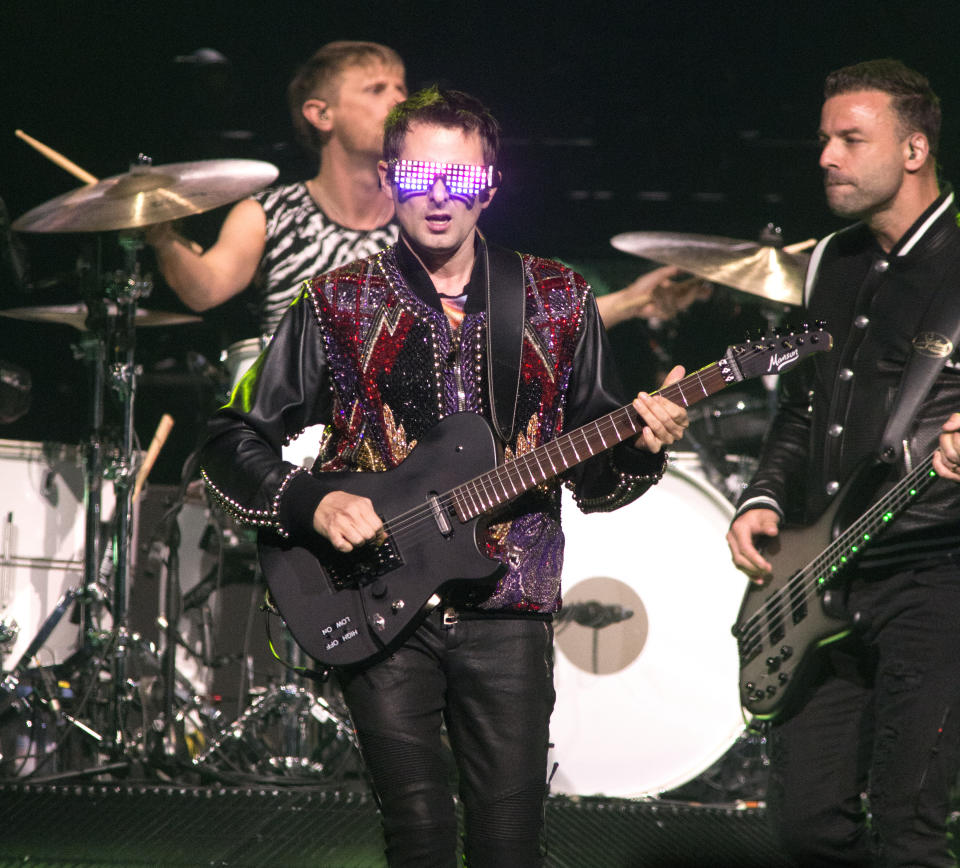 Dominic Howard, drummer, Matt Bellamy, center, and Chris Wolstenholme of the band Muse perform in concert during their "Simulation Theory World Tour" at The Wells Fargo Center on Sunday, April 7, 2019, in Philadelphia. (Photo by Owen Sweeney/Invision/AP)