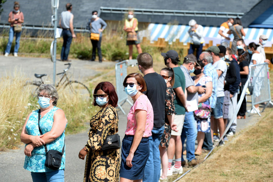 Image: People line up to have a COVID-19 test in Laval, France, as part of a massive testing campaign responding to an outbreak in the area. (Jean-Francois Monier / AFP - Getty Images)