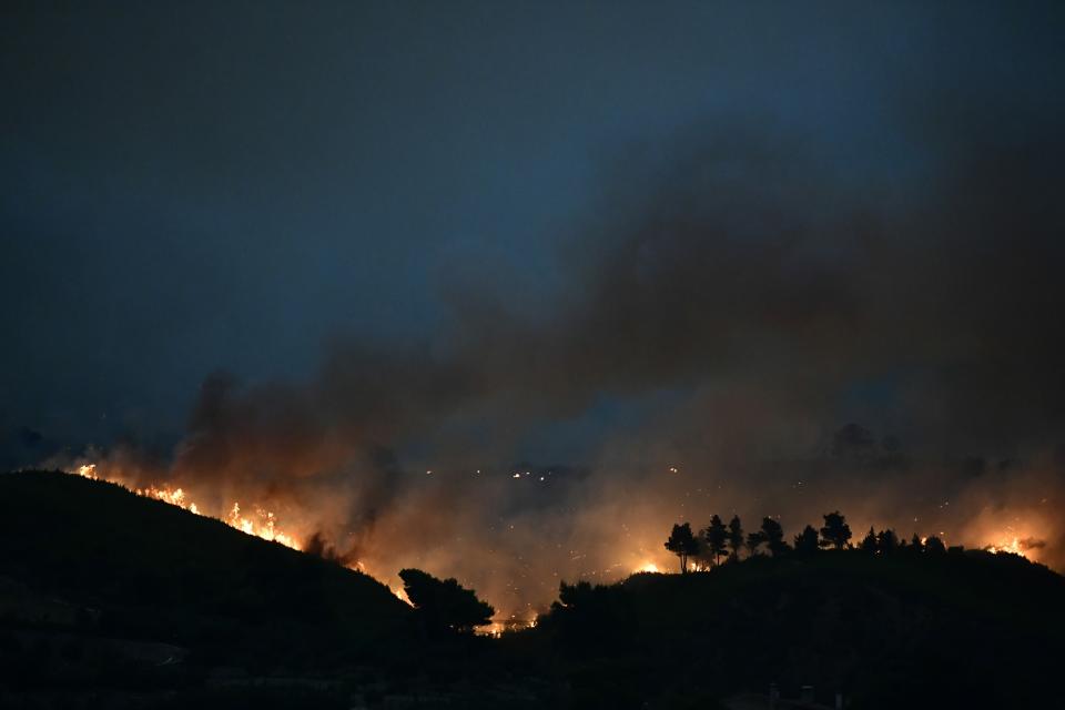 A wildfire burns a forest in Afidnes area, northern Athens, Greece, Thursday, Aug. 5, 2021.Wildfires rekindled outside Athens and forced more evacuations around southern Greece Thursday as weather conditions worsened and firefighters in a round-the-clock battle stopped the flames just outside the birthplace of the ancient Olympics. (AP Photo/Michael Varaklas)