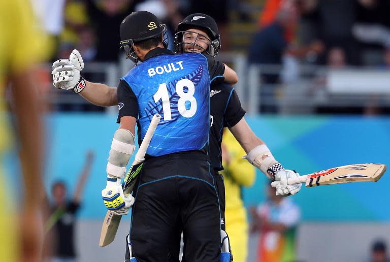 New Zealand's Kane Williamson (R) and Trent Boult celebrate victory against Australia during their 2015 Cricket World Cup Pool A match at Eden Park in Auckland on February 28, 2015