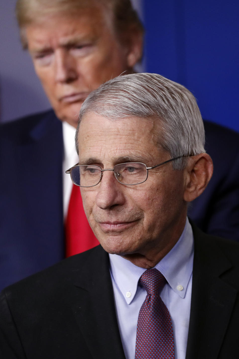 FILE - In this April 22, 2020, file photo President Donald Trump watches as Dr. Anthony Fauci, director of the National Institute of Allergy and Infectious Diseases, approaches the podium to speak about the coronavirus in the James Brady Press Briefing Room of the White House in Washington. (AP Photo/Alex Brandon, File)