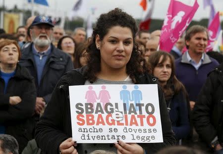 A protester holds a sign reading "It is wrong even if it becomes law" during a rally against same-sex unions and gay adoption in Rome, Italy January 30, 2016. REUTERS/Remo Casilli