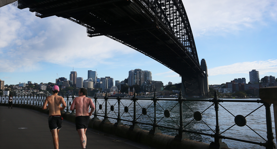 Two men run under Sydney Harbour where almost 3000kg of waste was removed from the water in a 12-month trial.