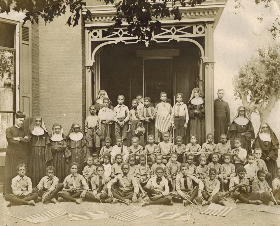 This 1911 photo provided by the Oblate Sisters of Providence shows a patriotic celebration at the Guardian Angels Home for Boys in Leavenworth, Kan. The Oblates ministered here from 1888 to 1959. Mother Mary Lange, who co-founded the Oblate Sisters of Providence in Baltimore in 1829, is among six Black Catholic Americans formally placed in the canonization process that could lead to sainthood. (Oblate Sisters of Providence via AP)