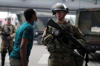 A man confronts a National Guard member as they guard the area in the aftermath of a protest in Minneapolis