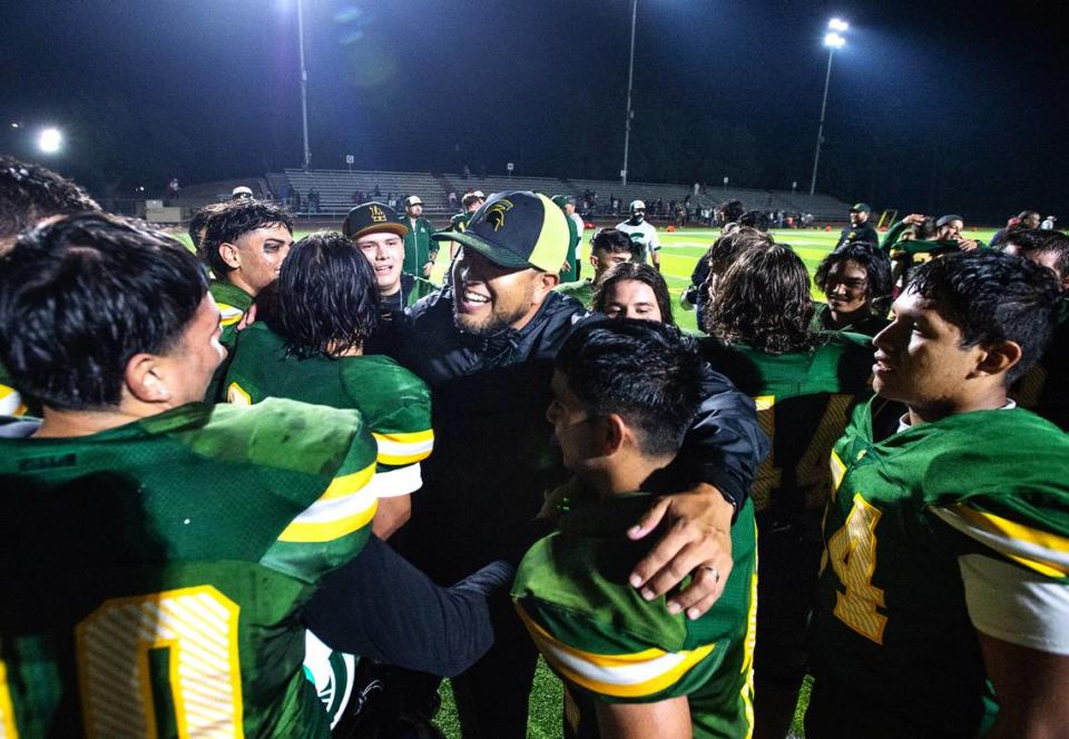 Davis coach Tim Garcia celebrates the 33-24 victory over Ceres with players in the Western Athletic Conference game at Downey High School in Modesto, Calif., on Thursday, Oct. 28, 2021. Andy Alfaro/aalfaro@modbee.com