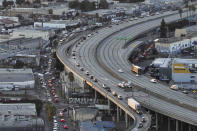 Motorists exit through a ramp off Interstate 10 as a section of the freeway is closed due to a fire in Los Angeles, Tuesday, Nov. 14, 2023. It will take at least three weeks to repair the freeway damaged in an arson fire, the California governor said Tuesday, leaving the city already accustomed to soul-crushing traffic without part of a vital artery that serves hundreds of thousands of people daily. (AP Photo/Jae C. Hong)