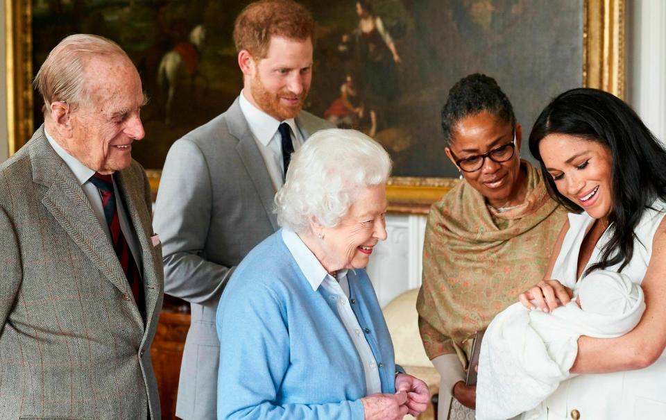 The Queen meeting Archie shortly after his birth. She may not see her great grandson again if the Duke of Sussex does not return to the UK - Chris Allerton/SussexRoyal via AP