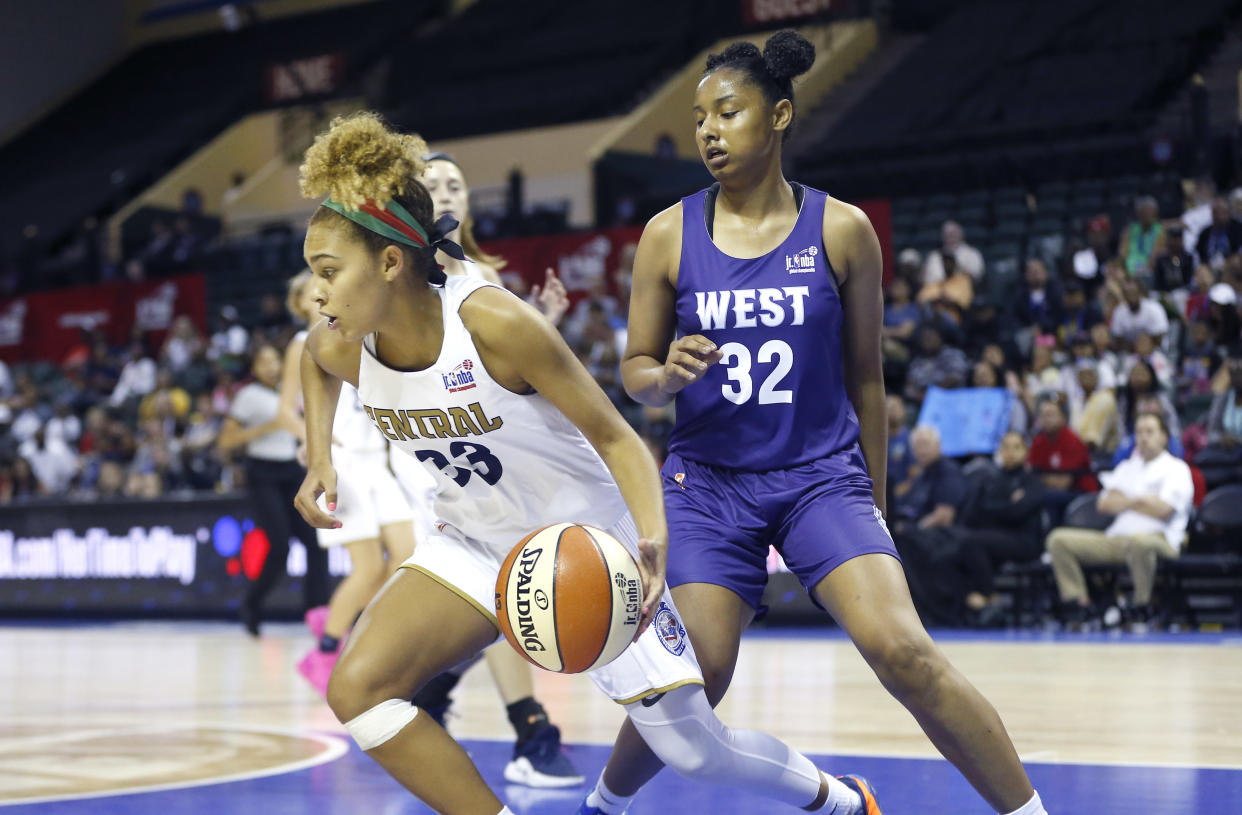 Central's Jada Williams (33) drives around the West's Judea Watkins (32) during the US Girls Championship game at ESPN Wide World of Sports Complex. Mandatory Credit: Reinhold Matay-USA TODAY Sports