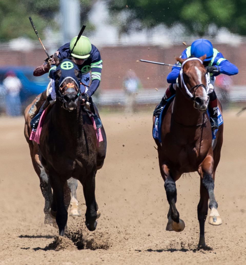 Jackie's Warrior, left, with jockey Joel Rosario aboard, wins the Pat Day Mile at Churchill Downs on Kentucky Derby Day. May 1, 2021