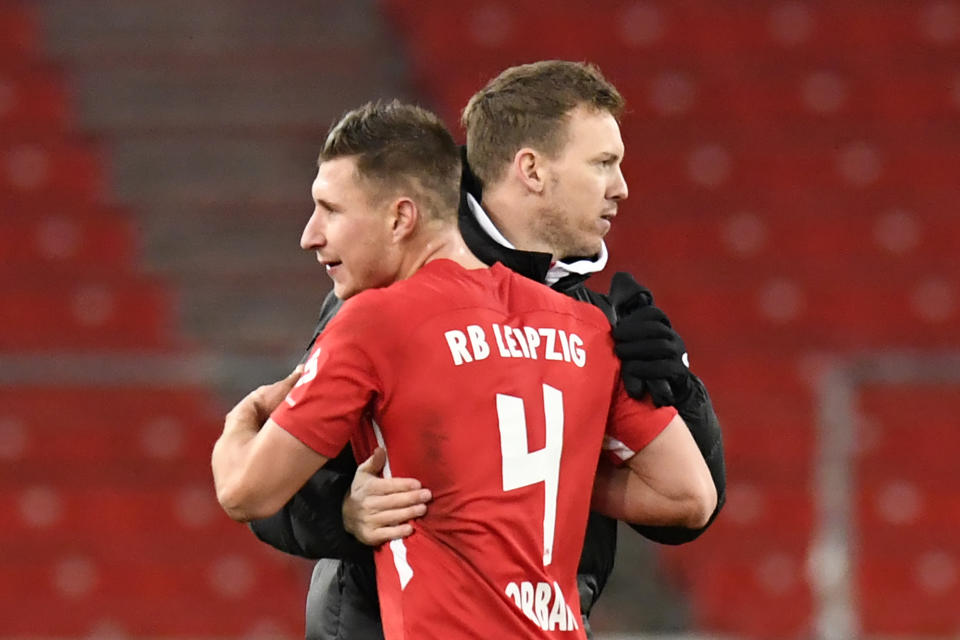 Leipzig's German headcoach Julian Nagelsmann (R) congratulates Leipzig's Hungarian defender Willi Orban after the German first division Bundesliga football match VfB Stuttgart v RB Leipzig on January 2, 2021 in Stuttgart, southern Germany. - Leipzig won the match 1-0. (Photo by Thomas KIENZLE / various sources / AFP) / DFL REGULATIONS PROHIBIT ANY USE OF PHOTOGRAPHS AS IMAGE SEQUENCES AND/OR QUASI-VIDEO (Photo by THOMAS KIENZLE/POOL/AFP via Getty Images)