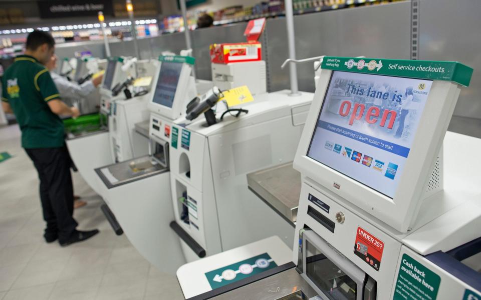 Self-service tills reduce the need for human workers in shops - Simon Dawson/Bloomberg