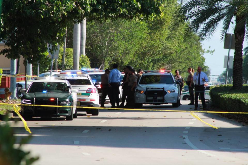 Miami-Dade County police officers and detectives investigate the discovery of three people found dead inside a car parked near Southwest 152nd Avenue and Bird Road Friday, June 7, 2024.