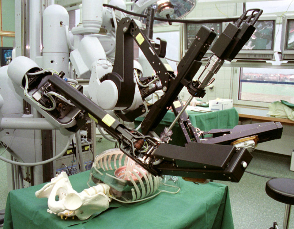 Pictures shows three robotic surgical arms at work in a worldwide operating theatre during a presentation for the media at the Leipzig Heart Center February 22. One of the arms holds a miniature camera, the other two hold standard surgical instruments. The surgeon watches a monitor with an image of the heart and manipulates the robotic arms with two handles. The software translates large natural movements into precise micro-movements in the surgical instruments.