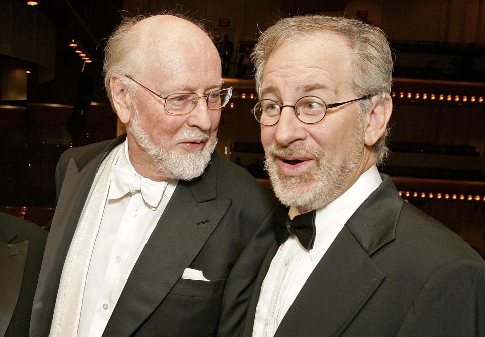 FILE - Conductor/composer John Williams appears with film director Steven Spielberg before the New York Philharmonic's Spring Gala in New York on April 26, 2006. Williams, 90, is devoting himself to composing concert music, including a piano concerto he’s writing for Emanuel X. This spring, he and cellist Yo-Yo Ma released the album “A Gathering of Friends,” recorded with the New York Philharmonic. It’s a radiant and soulful collection of cello concertos and new arrangements from the scores of “Schindler’s List,” “Lincoln” and “Munich." (AP Photo/Stephen Chernin, File)