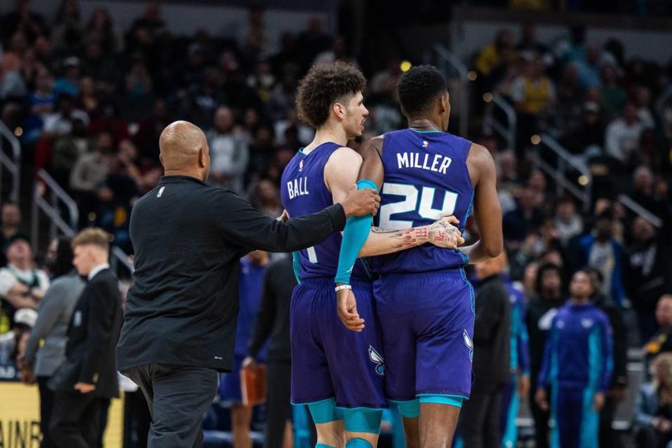 Charlotte Hornets guard LaMelo Ball (1) pulls forward Brandon Miller (24) away from the crowd in the second half against the Indiana Pacers at Gainbridge Fieldhouse.