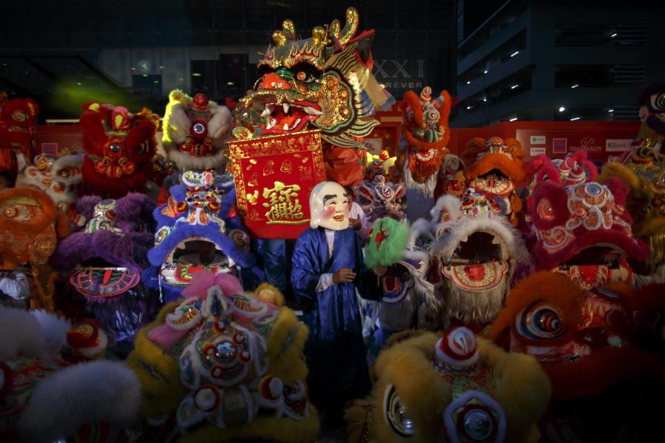 Lion and dragon dancers perform as part of the festive Chinese New Year celebrations in Bangkok's shopping district