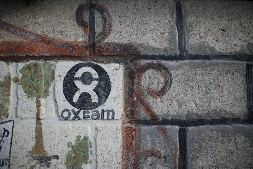 An Oxfam sign is seen on a wall in Corail, a camp for displaced people of the earthquake of 2010, on the outskirts of Port-au-Prince, Haiti, February 17, 2018. REUTERS/Andres Martinez Casares?