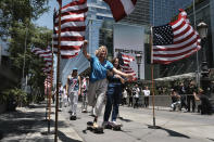 Members of the first U.S. Olympic skateboarding team arrive on their boards for a news conference in downtown Los Angeles on Monday, June 21, 2021. The team was introduced in Southern California, where the sport was invented roughly 70 years ago. Skateboarding is an Olympic sport for the first time in Tokyo, and the Americans are expected to be a strong team. (AP Photo/Richard Vogel)