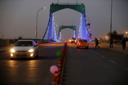 Cars drive past over a suspension bridge in the Green Zone in Baghdad, Iraq December 10, 2018. REUTERS/Thaier al-Sudani