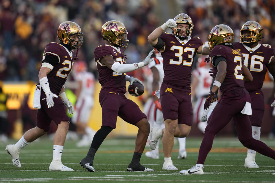 Minnesota defensive back Tyler Nubin, center left, celebrates with teammates after intercepting a pass during the second half of an NCAA college football game against Illinois, Saturday, Nov. 4, 2023, in Minneapolis. (AP Photo/Abbie Parr)