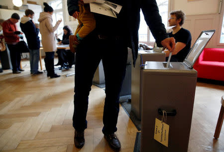 People cast their ballots in a ballot office to vote on the nuclear exit, in a school in Bern, Switzerland November 27, 2016. REUTERS/Ruben Sprich