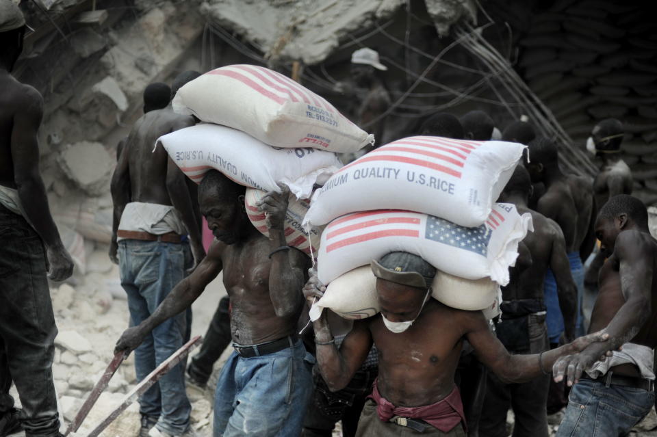 Workers remove rice from a warehouse after the earthquake in Port-au-Prince on Jan. 26, 2010.