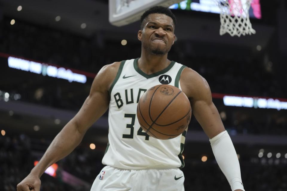 Milwaukee Bucks' Giannis Antetokounmpo reacts after a dunk during the first half of an NBA basketball game Monday, Nov. 13, 2023, in Milwaukee. (AP Photo/Morry Gash)