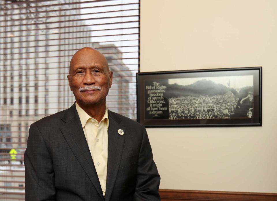 Malcolm Costa, CEO of Community Action Akron Summit,  stands in his office next to a photograph of the Rev. Martin Luther King Jr. speaking at the March on Washington for Jobs and Freedom on Aug. 28, 1963. Costa's father used to own a barbershop on Wooster Avenue.