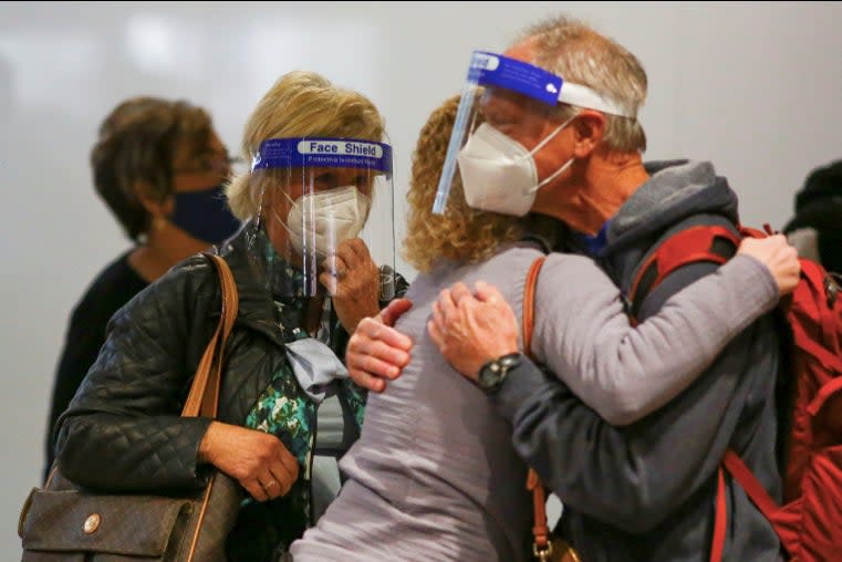 <p>Millions of Americans are reuniting after months apart – despite health warnings not to travel as the pandemic rages on</p> (Reuters)
