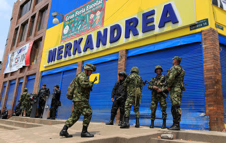 Colombian police and soldiers guard a supermarket supposedly linked to FARC in Bogota, Colombia February 21, 2018. REUTERS/Jaime Saldarriaga