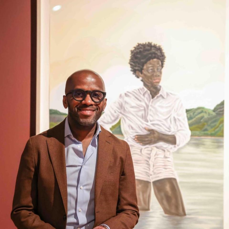 Dextex Wimberly, who curated the Gantt Center’s “A Superlative Palette” exhibit, with one of the paintings in the show - a Toyin Ojih Odutola piece called “By Her Design.”