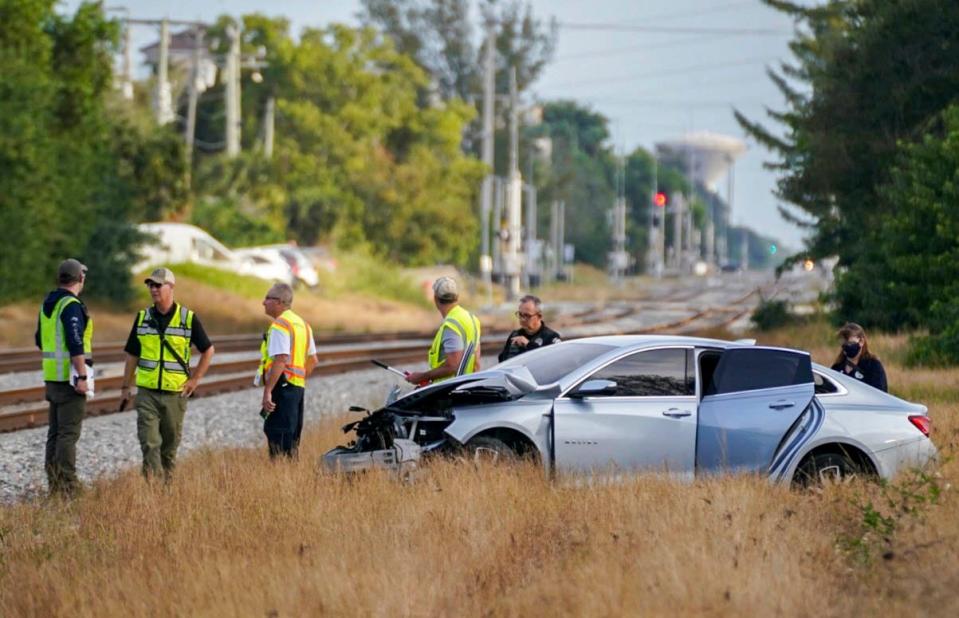 Officials survey the area around a Chevrolet Malibu that was driven by an unidentified woman and a baby passenger when the car was hit by a Brightline train heading south on the FEC railway tracks at Southeast 10th Street and South Swinton Avenue in Delray Beach. The wreck took place about 6:30 a.m. The woman and the baby escaped injury. This was the second of two Brightline crashes in Palm Beach County since Sunday, Feb. 13, when a train struck a car in Lake Worth Beach, killing one person.