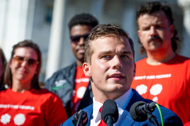 Madison Cawthorn speaks at a press conference in November with several supporters standing behind him