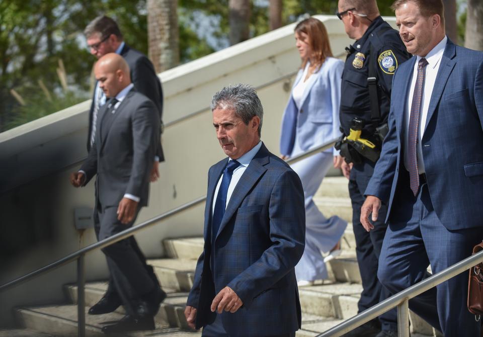 Carlos De Oliveira (center) and his Washington D.C. attorney John Irving (right) leave the federal courthouse in Fort Pierce on Thursday, Aug 10, 2023, after appearing before U.S. Magistrate Shaniek Mills Maynard to face new charges added July 27 to an indictment in the classified documents case. De Oliveira did not enter a plea but rescheduled the arraignment for Tuesday, Aug. 15. Waltine "Walt" Nauta (left) and his attorney Sasha Dadan (background), of Fort Pierce, follow down the steps..