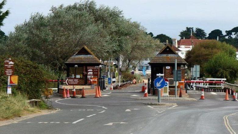 Two toll collection booths next to road barriers on Ferry Road.