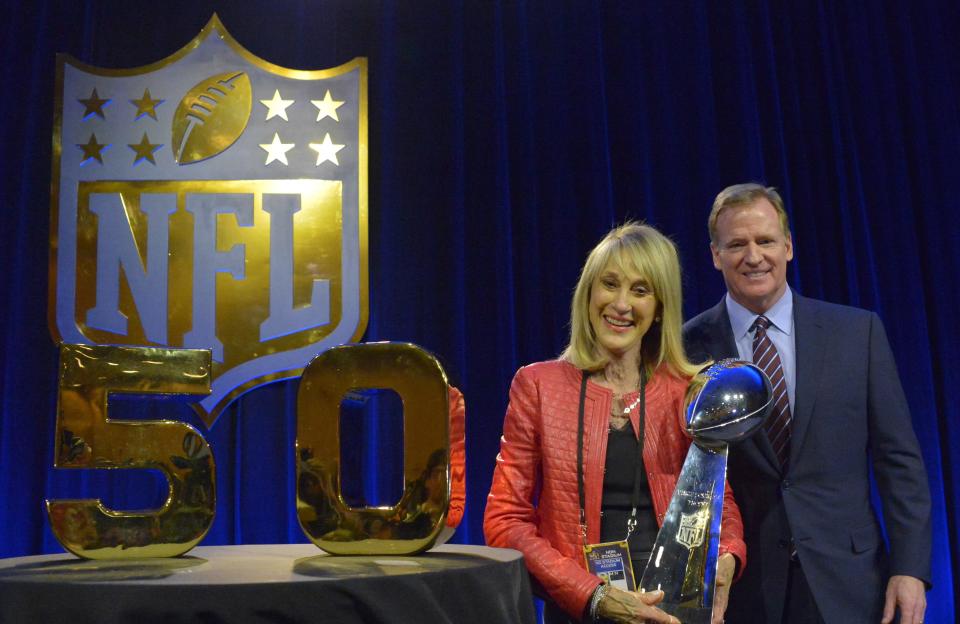 Kansas City Chiefs' Norma Hunt and NFL commissioner Roger Goodell pose with the Lombardi Trophy before Super Bowl 50.