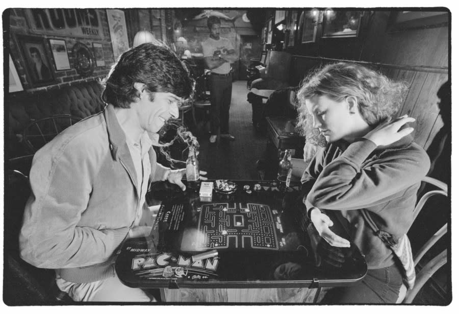 Author David Sudnow and a woman play a table top Pac-Man game at a Berkeley restaurant. (Photo by © Roger Ressmeyer/CORBIS/VCG via Getty Images)