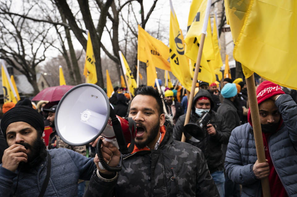 Protesters lead a chant on Fifth Avenue outside the Consulate General of India, Tuesday, Jan. 26, 2021, in the Manhattan borough of New York. Tens of thousands of protesting farmers have marched, rode horses and drove long lines of tractors into India's capital, breaking through police barricades to storm the historic Red Fort. The farmers have been demanding the withdrawal of new laws that they say will favor large corporate farms and devastate the earnings of smaller scale farmers. Republic Day marks the anniversary of the adoption of India’s constitution on Jan. 26, 1950. (AP Photo/John Minchillo)