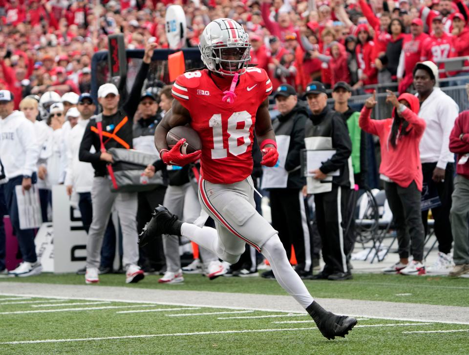 Oct 21, 2023; Columbus, Ohio, USA; Ohio State Buckeyes wide receiver Marvin Harrison Jr. (18) makes a catch and then scores a touchdown on the run against Penn State Nittany Lions during the fourth quarter of their game at Ohio Stadium.