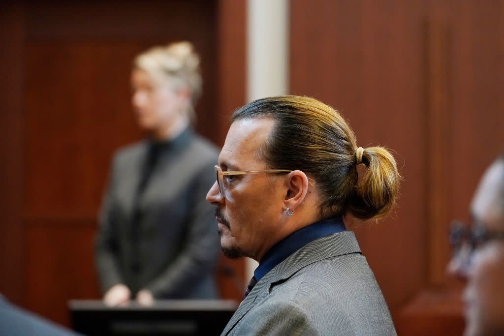 Actors Amber Heard and Johnny Depp watch as the jury comes into the courtroom after a break at the Fairfax County Circuit Courthouse in Fairfax, Va., on May 16, 2022. (Photo by Steve Helber / POOL / AFP) (Photo by STEVE HELBER/POOL/AFP via Getty Images)<span class="copyright">POOL/AFP via Getty Images</span>
