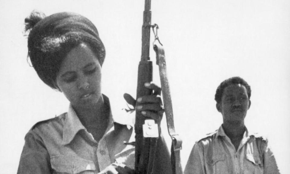 FILE - In this Feb. 25, 1978 file photo, a Somali Army female recruit checks her automatic weapon at a military training camp in Halane, Mogadishu. At right is her instructor. On Friday, Aug. 23, 2019, The Associated Press reported on this photo circulating online, incorrectly identified as showing U.S. Rep. Ilhan Omar, D-Minn., undergoing military training. This black-and-white film image was made before Omar was born. (AP Photo)