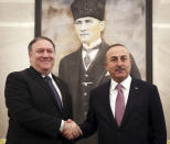 Turkey's Foreign Minister Mevlut Cavusoglu, right, and U.S. Secretary of State Mike Pompeo shake hands before a meeting at the Esenboga Airport in Ankara, Turkey, Wednesday, Oct. 17, 2018. Pro-government newspaper Yeni Safak on Wednesday said it had obtained audio recordings of the alleged killing of Saudi writer Jamal Khashoggi inside the Saudi Arabia's consulate in Istanbul on Oct. 2. (Cem Ozdel/Turkish Foreign Ministry via AP)