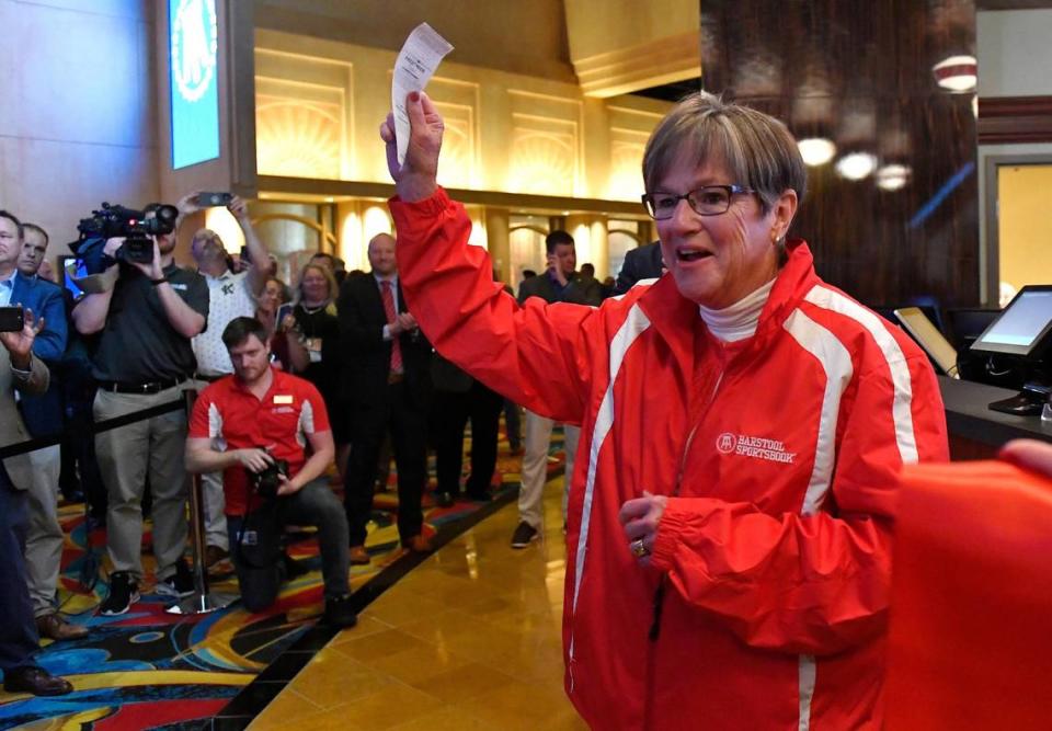 Kansas Gov. Laura Kelly places the first legal sports bet in Kansas in September and turns toward an enthusiastic crowd after putting her money on the Kansas City Chiefs.