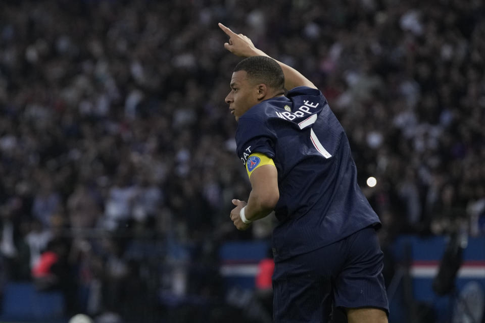 PSG's Kylian Mbappe celebrates after scoring his side's opening goal during the French League One soccer match between Paris Saint-Germain and Toulouse at the Parc des Princes stadium in Paris, Sunday, May 12, 2024. (AP Photo/Christophe Ena)