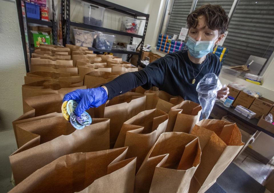 A person assembling kits to be distributed to people that are unhoused in Los Angeles County.