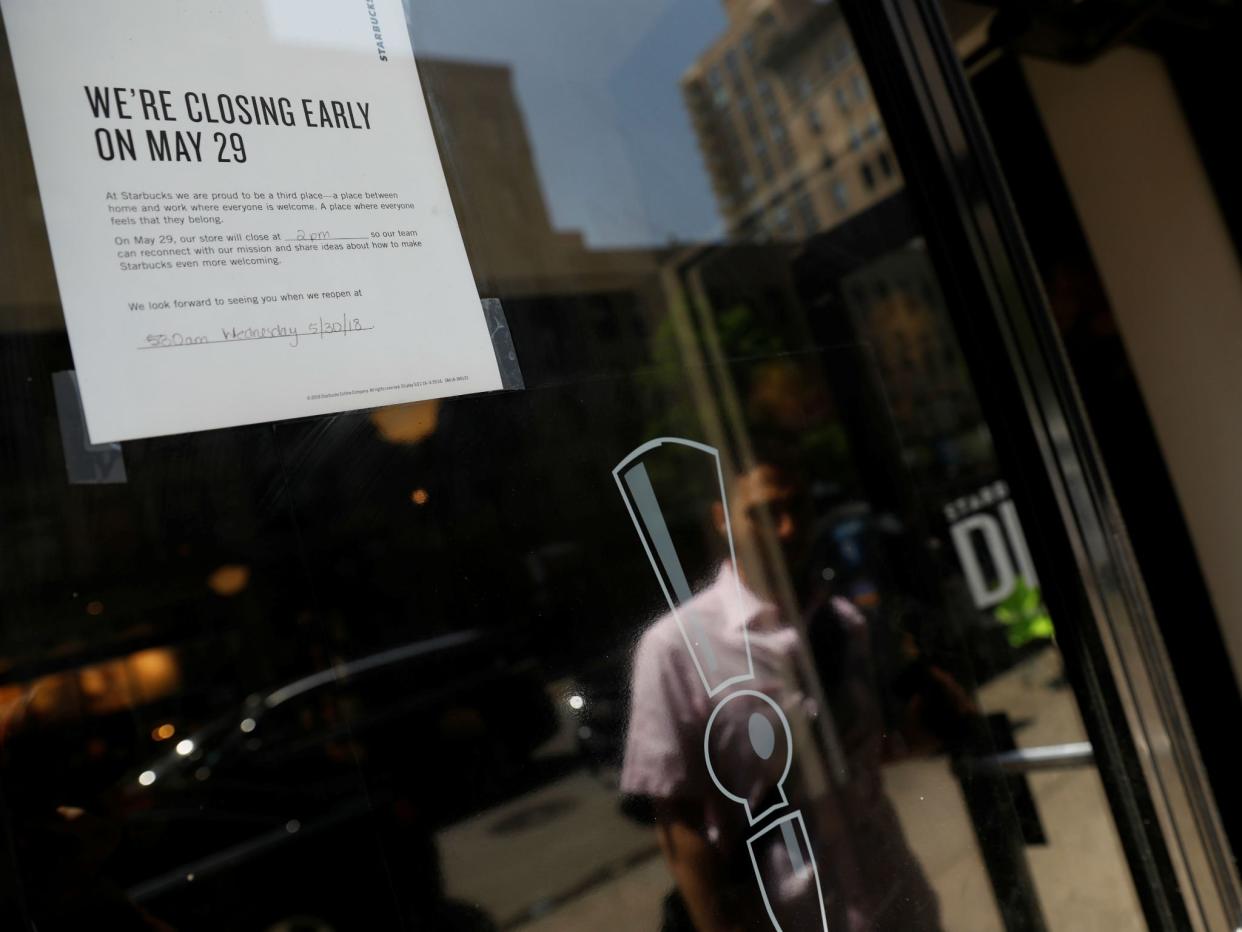 A sign in the window of a door of a Starbucks explains the store will close early for racial bias training: REUTERS/Shannon Stapleton