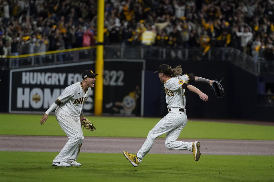 San Diego Padres third baseman Manny Machado, left, celebrates with relief pitcher Josh Hader after the Padres defeated the Los Angeles Dodgers 5-3 in Game 4 of a baseball NL Division Series, Saturday, Oct. 15, 2022, in San Diego.(AP Photo/Jae C. Hong)